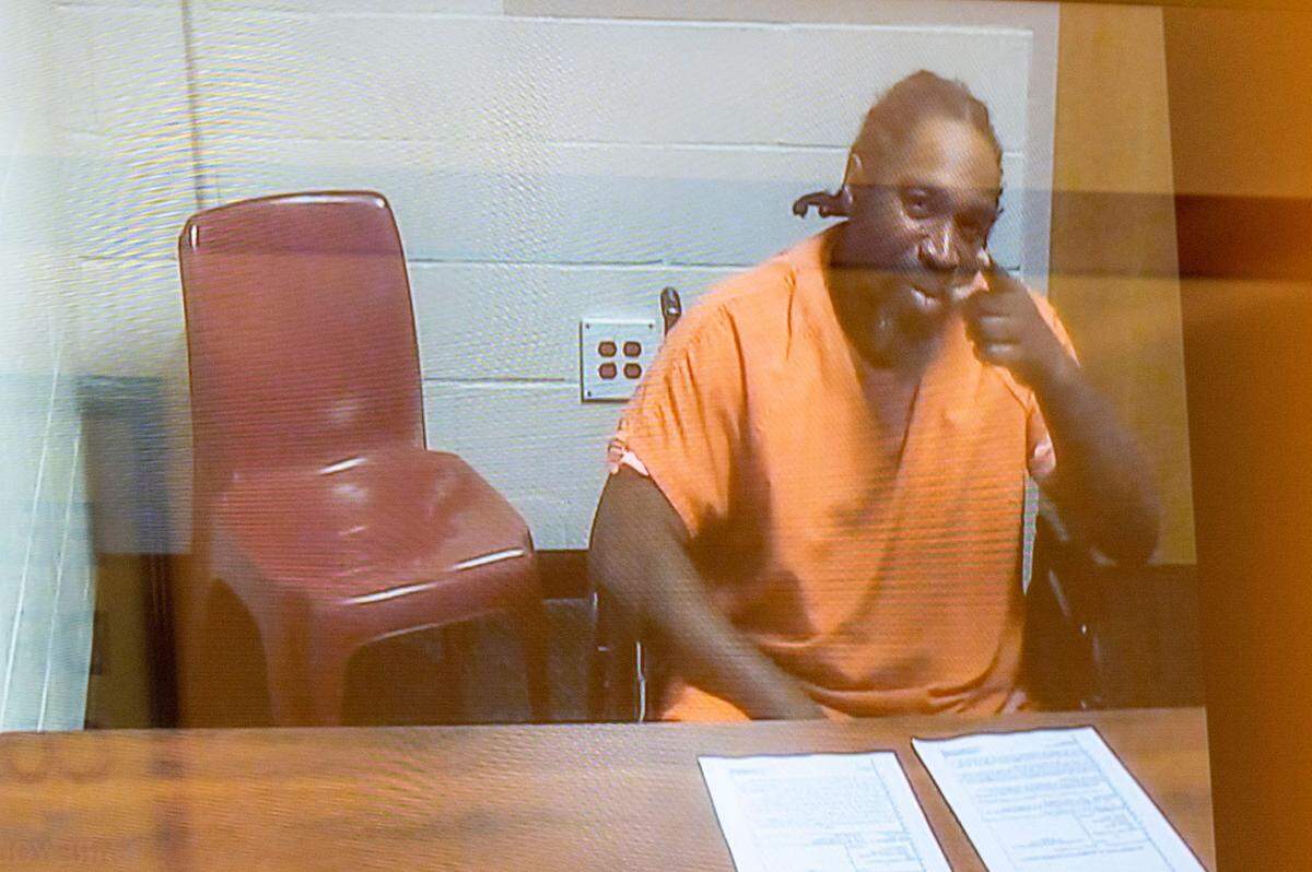 Kenny Lamont Haymore points at a camera while remotely appearing for an arraignment hearing in Pierce County Superior Court on Friday, Oct. 7, 2022, in Tacoma, Wash. Haymore was charged with second-degree murder in the Oct. 1, 2022 fatal shooting of a 49-year-old man. Bail was set for $1 million.