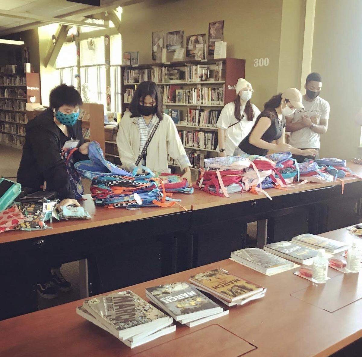 Volunteers pack diverse books that will be delivered to children.