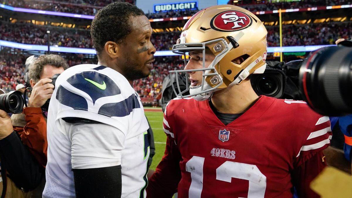 Seattle Seahawks quarterback Geno Smith, left, greets San Francisco 49ers quarterback Brock Purdy after an NFL wild card playoff football game in Santa Clara, Calif., Saturday, Jan. 14, 2023. The 49ers won 41-23. (AP Photo/Godofredo A. Vásquez)