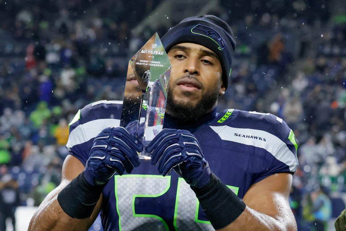 Seattle Seahawks linebacker Bobby Wagner holds a Payton Manning Man of the Year crystal during an NFL football game against the Philadelphia Eagles, Monday, Dec. 18, 2023, in Seattle. (AP Photo/John Froschauer)