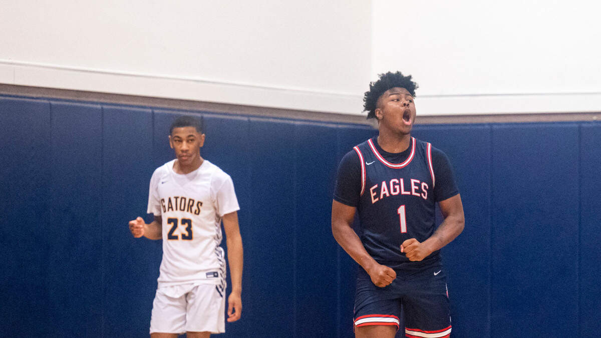 Life Christian guard Daishaun Nichols (1) celebrates after forcing a turnover as Annie Wright guard TJ Marshall (23) looks on during the fourth quarter of a 1A Nisqually League game on Thursday, Feb. 10, 2022, at Annie Wright School in Tacoma, Wash.