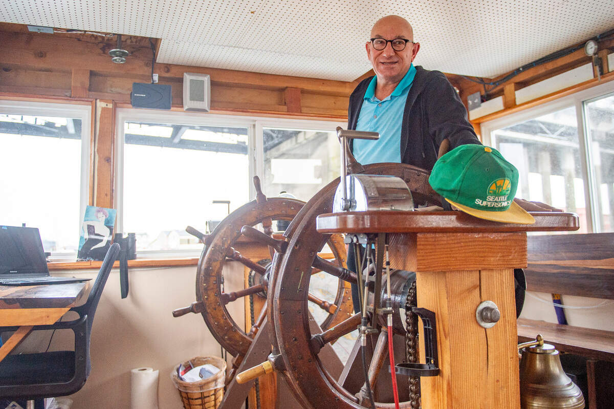 Dennis Redmon stands in between the dual steering wheels on the Annabelle on Tuesday, Dec. 14, 2021, in the Foss Waterway in Tacoma. Redmon and his wife, Katherine, have called the 70-foot ferry home for nearly 30 years.