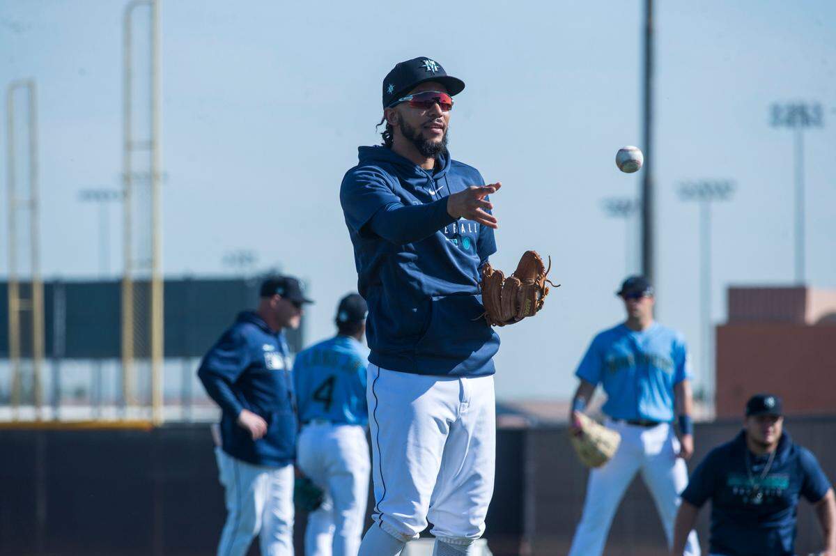 Seattle Mariners shortstop J.P. Crawford tosses a ball during a fielding drill at spring training on Tuesday, Feb. 18, 2020 in Peoria, Ariz.