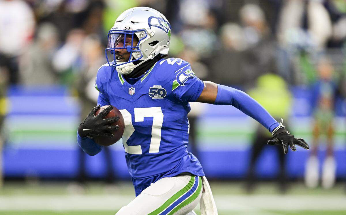 Seattle Seahawks cornerback Riq Woolen (27) runs back the interception against the Minnesota Vikings during the fourth quarter of the game at Lumen Field, on Sunday, Nov. 30, 2025, in Seattle. He would fumble is and be recovered by Minnesota.