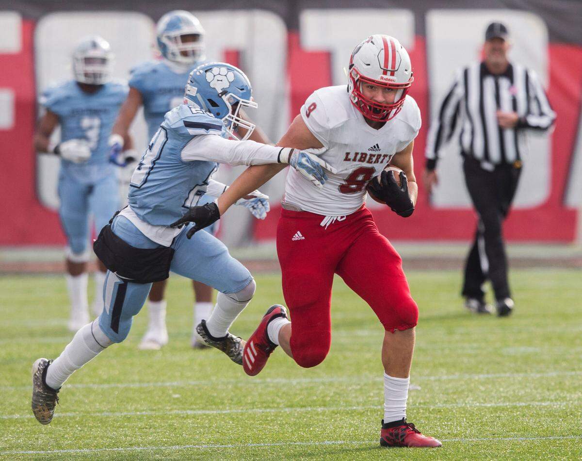 Liberty junior tight end Moliki Matavao (9) breaks into the open field past Centennial junior Jordan McGilbra (23) in the fourth quarter during the Class 4A state football championship game on Saturday, Dec. 7, 2019, at Sam Boyd Stadium, in Las Vegas.