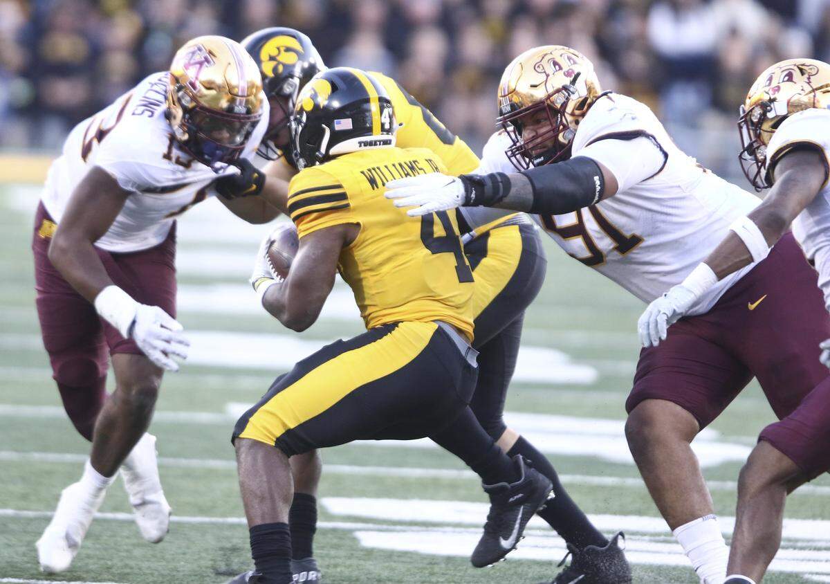 IOWA CITY, IOWA- OCTOBER 21: Defensive lineman Deven Eastern #91 of the Minnesota Golden Gophers makes a tackle during the second half on running back Leshon Williams #4 of the Iowa Hawkeyes at Kinnick Stadium on October 21, 2023 in Iowa City, Iowa. (Photo by Matthew Holst/Getty Images)