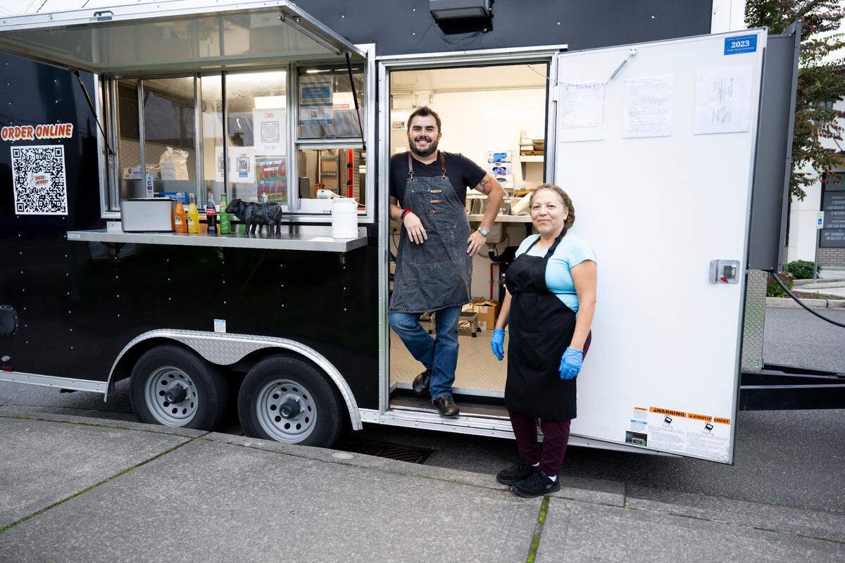 Owner Franco Mendiola and cook Reina Lemus pose for a photo at Tacos Mirrey, parked outside of Top Down Brewing in Sumner on Saturday, Oct. 21.