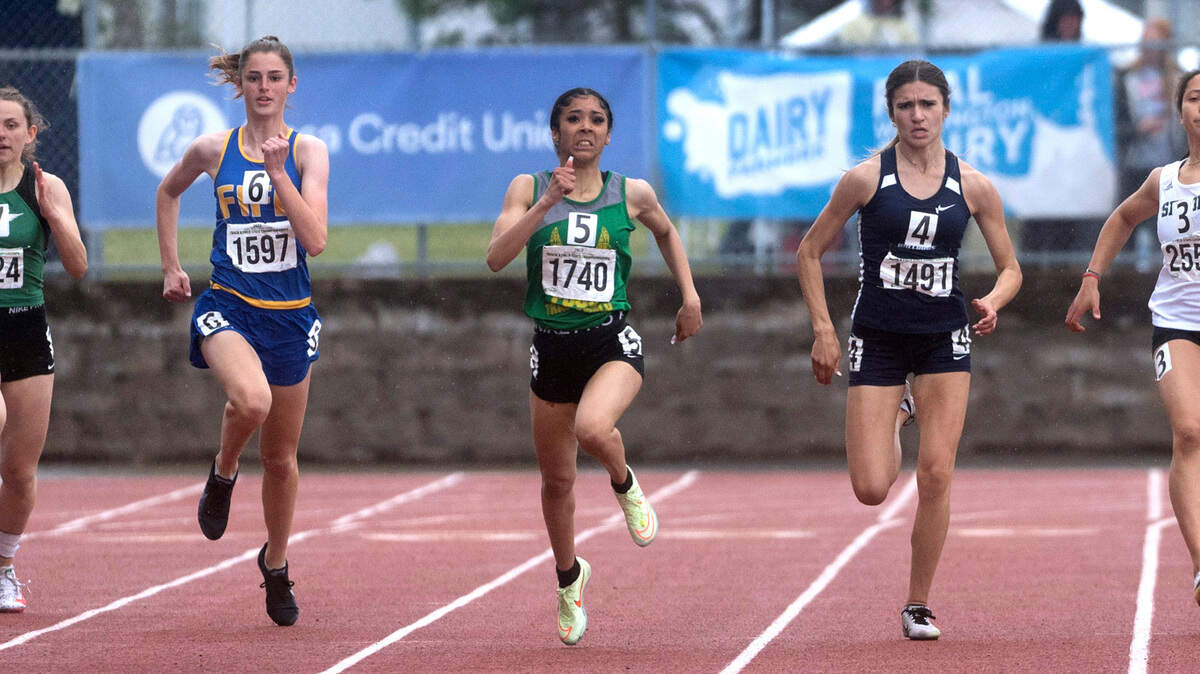 Foss’ Rhonda Newton (center) runs to a state championship in the 2A girls 200-meter dash during the final day of the WIAA State Track and Field Championships at Mount Tahoma High School in Tacoma, Washington on Saturday, May 28, 2022.