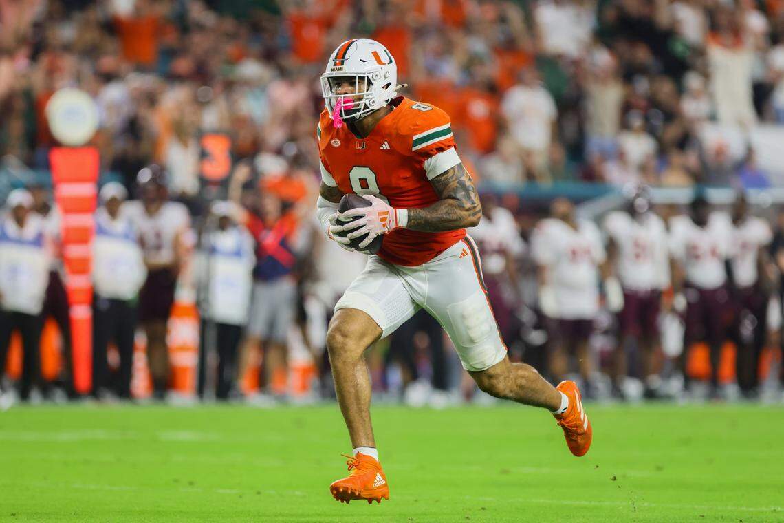 Sep 27, 2024; Miami Gardens, Florida, USA; Miami Hurricanes tight end Elijah Arroyo (8) runs with the football for a touchdown against the Virginia Tech Hokies during the first quarter at Hard Rock Stadium. Mandatory Credit: Sam Navarro-Imagn Images