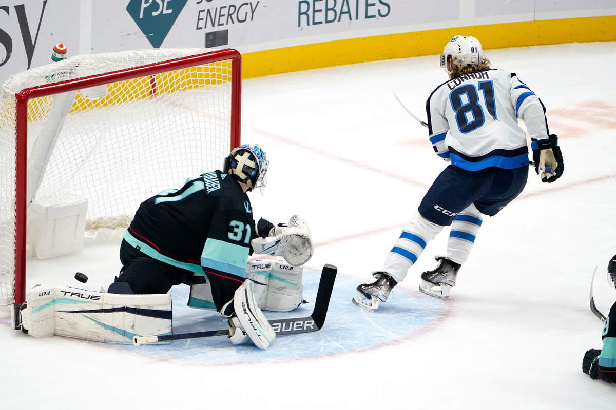 Winnipeg Jets’ Kyle Connor (81) skates away after scoring on Seattle Kraken goaltender Philipp Grubauer during the third period of an NHL hockey game Thursday, Dec. 9, 2021, in Seattle. The Jets won 3-0. (AP Photo/Elaine Thompson)