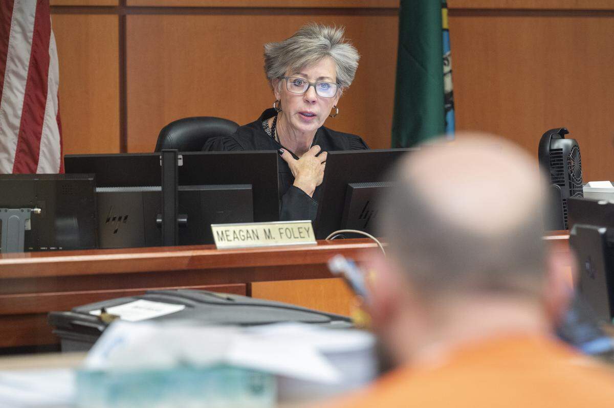 Pro Tem Court Commissioner Meagan Foley speaks to Nicholas Badger Prather, right, at his arraignment on Monday, Dec. 8, 2025, at Pierce County Superior Court in Tacoma, Wash. Prather, 42, has been charged with first-degree murder in the Dec. 5 shooting of a 14-year-old boy on McKinley Avenue in Tacoma.