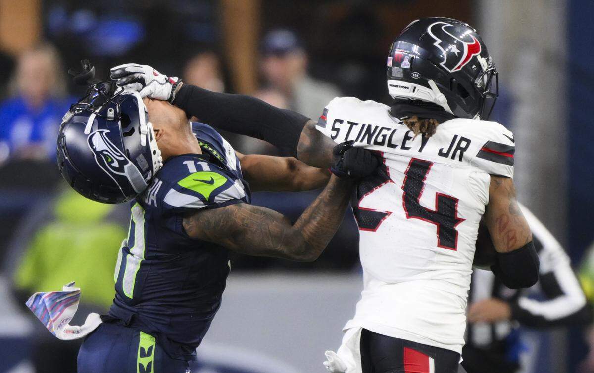 Seattle Seahawks wide receiver Jaxon Smith-Njigba (11) loses his helmet attempting to stop Houston Texans cornerback Derek Stingley Jr. (24) as he runs back the interception during the fourth quarter of the game at Lumen Field, on Monday, Oct. 20, 2025, in Seattle.