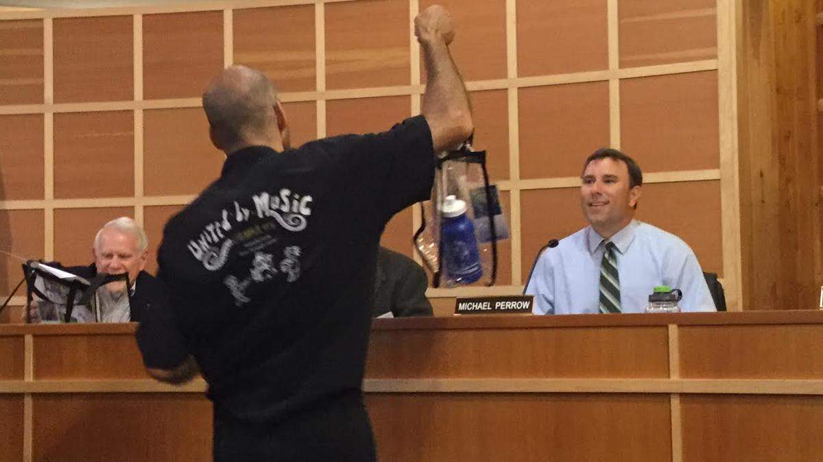 Gig Harbor City Council member Michael Perrow was presented a gift, along with the other members of the council, by singers and musicians from United by Music North America during a presentation on Monday, July 9.