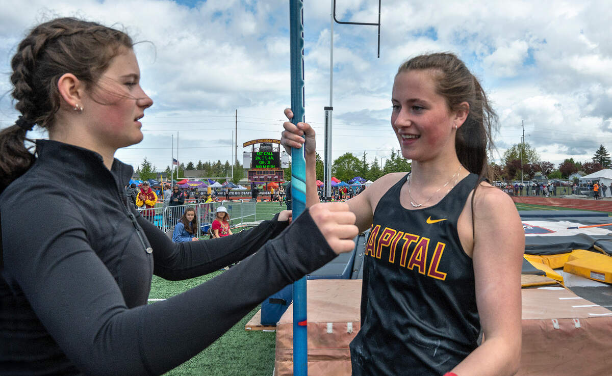 Capital junior twins Hana (left) and Amanda Moll after taking the top two spots in the 3A girls pole vault competition during the second day of the WIAA State Track and Field Championships at Mount Tahoma High School in Tacoma, Washington on Friday, May 27, 2022.