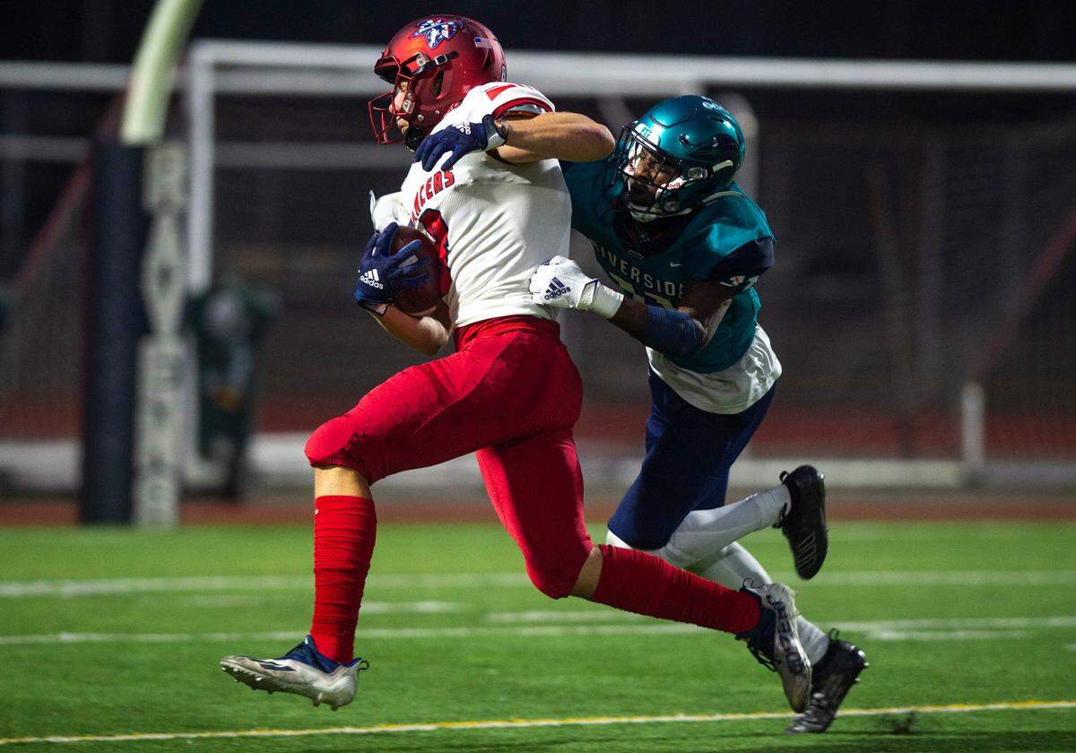 Kennedy Catholic wide receiver Mason Hayes (8) runs towards the end zone as Auburn Riverside defensive back Carter Rhooms (11) tackles him right before he reaches it in the second quarter of a game at Auburn Memorial Stadium in Auburn, Wash. on Oct. 6, 2022.
