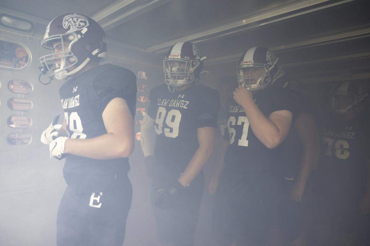 The Enumclaw Hornets offensive line prepares to take the field from the hog truck they enter in before the game against the Decatur Golden Gators at Pete’s Pool, on Thursday, Sept. 4, 2025, in Enumclaw, Wash.