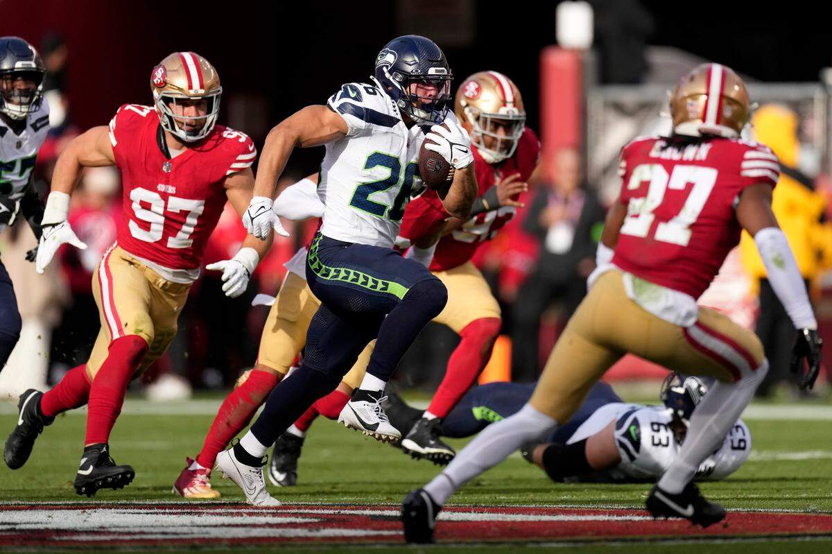 Seattle Seahawks running back Zach Charbonnet (26) runs against the San Francisco 49ers during the first half of an NFL football game in Santa Clara, Calif., Sunday, Dec. 10, 2023. (AP Photo/Godofredo A. Vásquez)