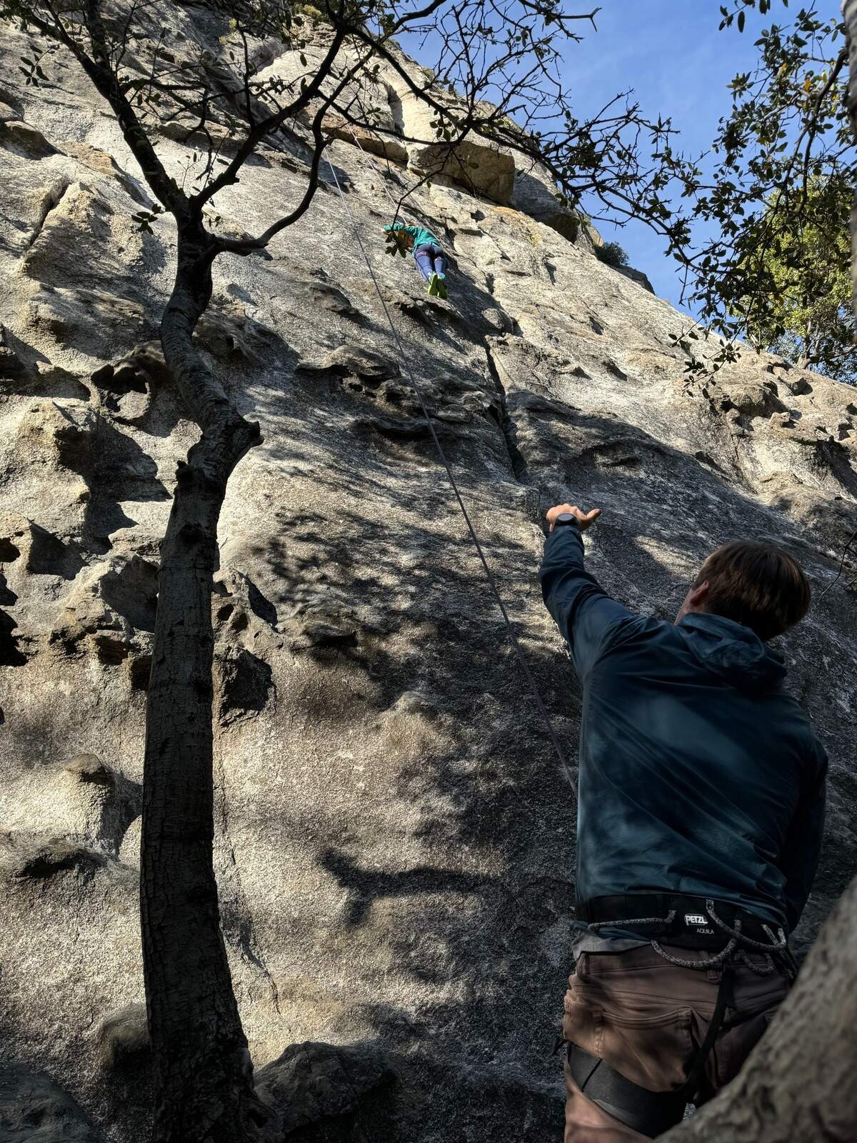 The author and his daughter “top roping” at a crag with a bolted anchor.