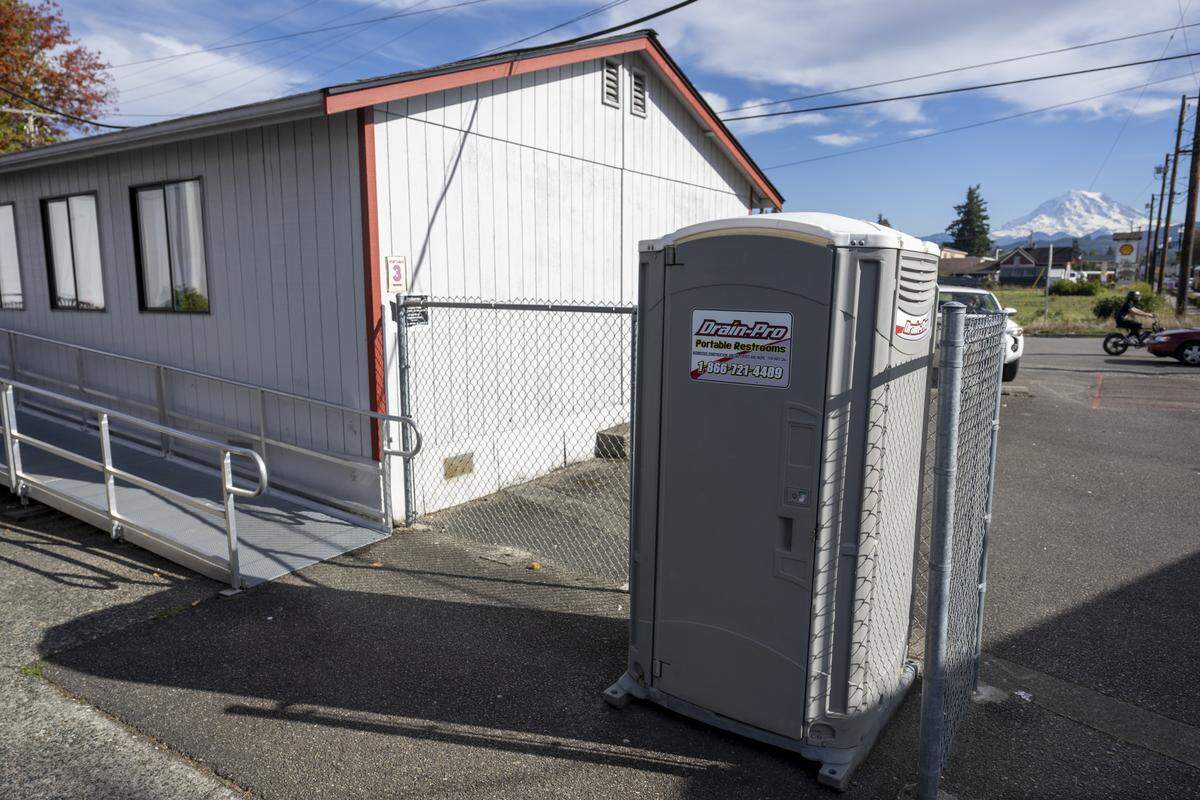 A port-a-potty sits near a collection of portables used for Orting High School student classrooms on Wednesday, Oct. 15, 2025, in Orting, Wash.