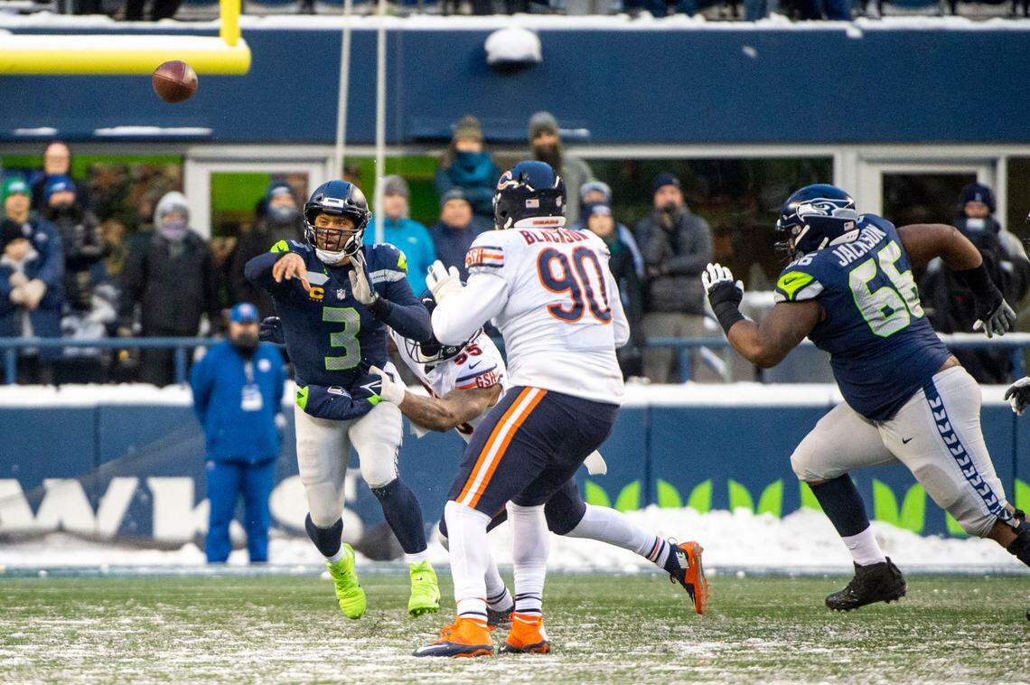 Seattle Seahawks quarterback Russell Wilson (3) is tackled by Chicago Bears linebacker Bruce Irvin (55) as he attempts a pass to wide receiver Tyler Lockett (16) on fourth down in the fourth quarter of an NFL game on Sunday afternoon at Lumen Field in Seattle.