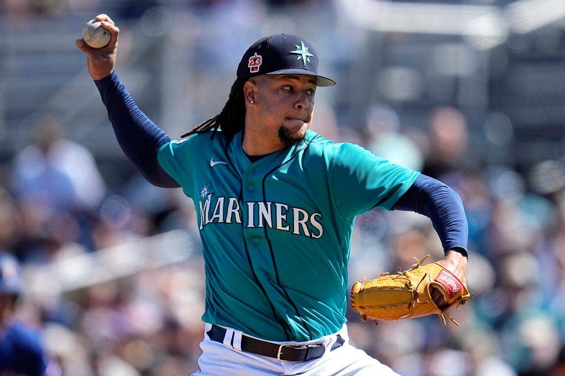 Seattle Mariners starting pitcher Luis Castillo delivers during the second inning of a spring training baseball game against the Texas Rangers, Sunday, March 12, 2023, in Peoria, Ariz. (AP Photo/Abbie Parr)