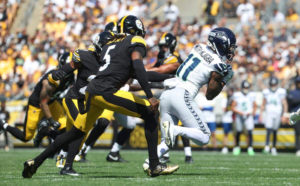 Sep 14, 2025; Pittsburgh, Pennsylvania, USA; Seattle Seahawks wide receiver Jaxon Smith-Njigba (11) runs after catch against Pittsburgh Steelers cornerback Jalen Ramsey (5) during the first quarter t Acrisure Stadium. Mandatory Credit: Charles LeClaire-Imagn Images