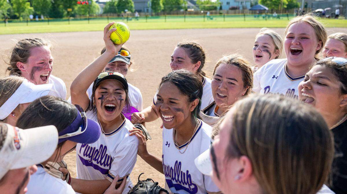 Puyallup players celebrate after beating Emerald Ridge, 8-5, to win the 4A West Central/Southwest district softball championship game at Kent Service Fields on Saturday, May 20, 2023, in Kent, Wash.