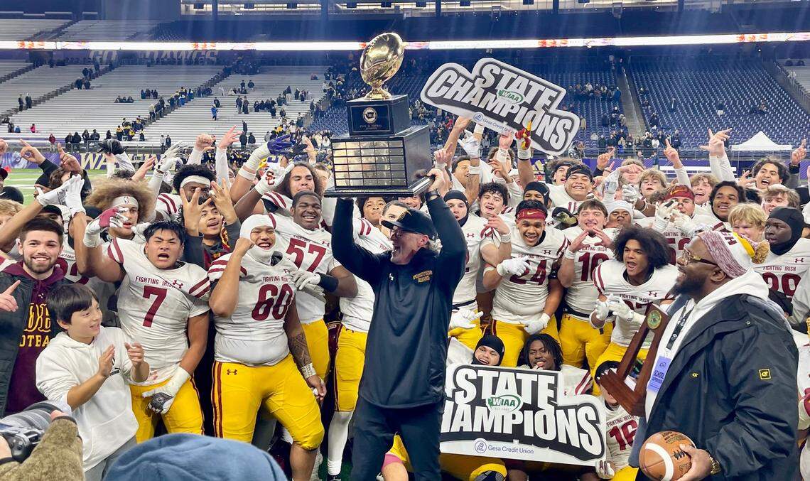 O’Dea coach Monte Kohler hoists the state championship trophy after O’Dea defeated Bellevue in the Class 3A state championship high school football game at Husky Stadium in Seattle, Wash. on Friday, Dec. 6, 2024.