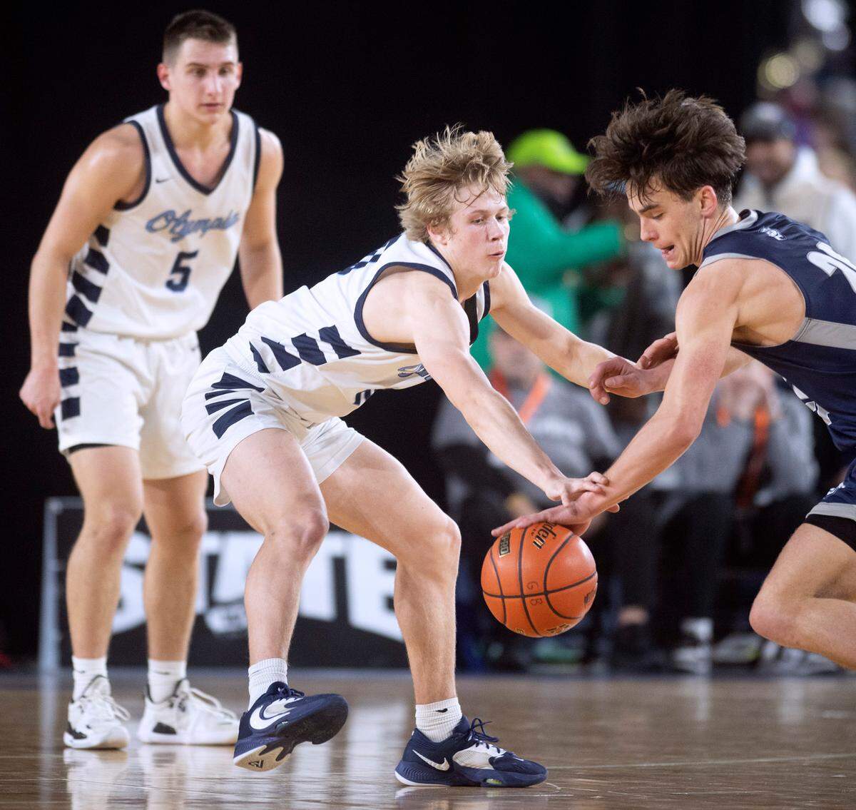 Olympia defender Drew Carlson knocks the ball loose from Gonzaga Prep’s Henry Sandberg during their state quarterfinal game at the WIAA state basketball tournament in the Tacoma Dome in Tacoma, Washington, on Wednesday, March 1, 2023. Olympia won the game, 51-47.