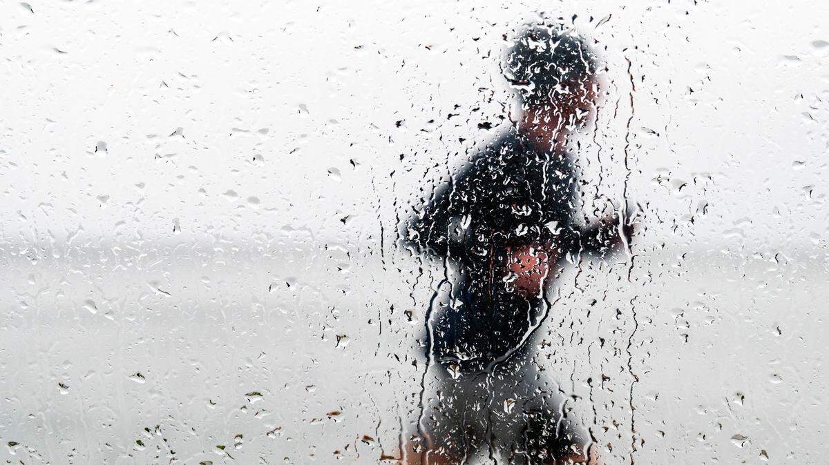 A man jogs along the Ruston Way Path on a rainy Saturday afternoon in Tacoma.