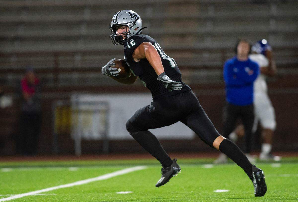 Emerald Ridge tight end Jacob Lane (12) runs down the field and into the end zone to score a touchdown after intercepting a pass thrown by Curtis quarterback Rocco Koch (15) in the third quarter of a game at Sparks Stadium in Puyallup, Wash. on Sept. 22, 2022. Emerald Ridge defeated Curtis 42-13.