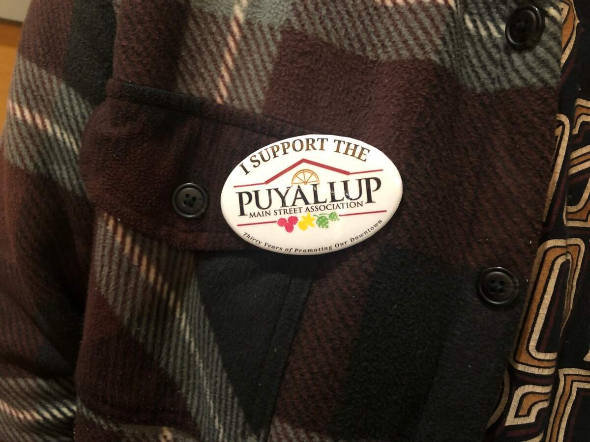 “I Support the Puyallup Main Street Association” (PMSA) buttons were handed out prior to the Puyallup City Council meeting on Feb. 26. The nonprofit feels singled out by a process approved by Council to put three events typically managed by PMSA out for bid.