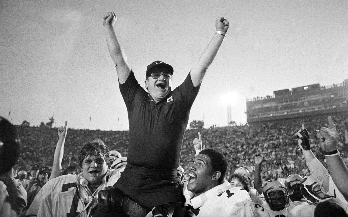 In this Jan. 1, 1981, file photo, Michigan coach Bo Schembechler is carried from the field by Glen Dwyer (71) and Ed Muransky, left, after a 23-6 win over Washington in the Rose Bowl in Pasadena, Calif.