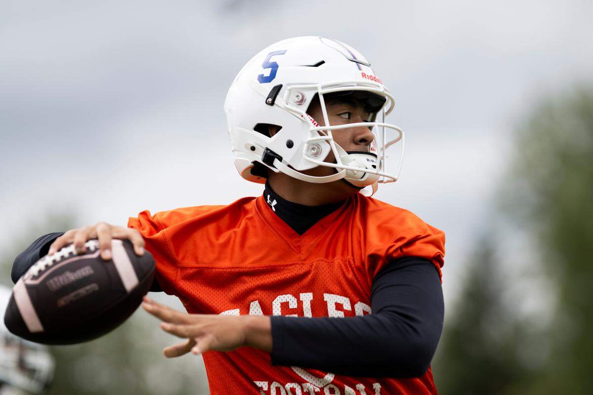 Graham-Kapowsin quarterback throws a pass during a football practice at Graham-Kapowsin High School, on Thursday, Aug. 22, 2024, in Graham, Wash.
