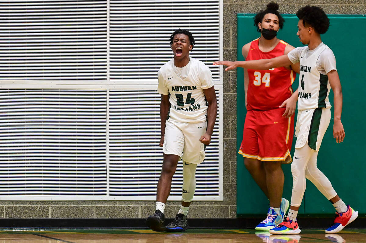 Auburn guard Dae’Kwon Watson (24) celebrates after scoring a layup and being fouled as Mount Tahoma forward Marquise Thorpe-Taylor (34) looks away during the third quarter of a non-league game on Thursday, Jan. 20, 2022, at Auburn High School.