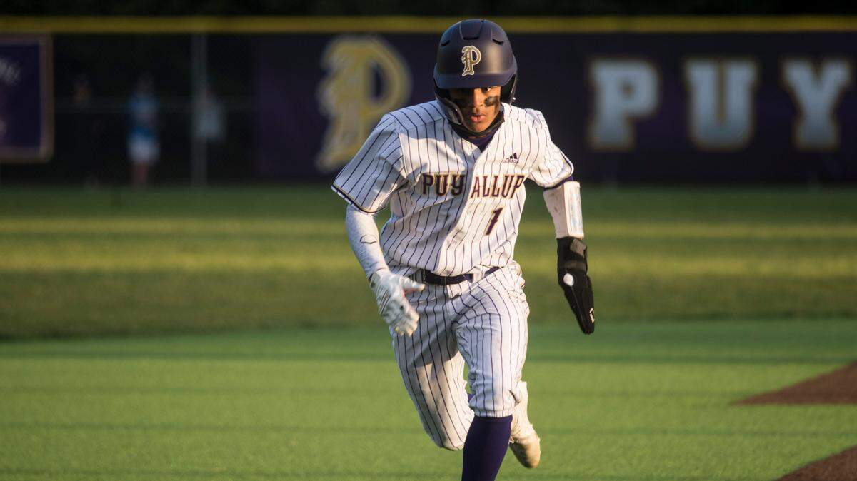 Puyallup High School’s Donte Grant steals a base during the 4A SPSL championship game against Olympia on Saturday, May 1, 2021 at Heritage Recreation Center in Puyallup, Wash. The Vikings won, 4-3, in extra innings.