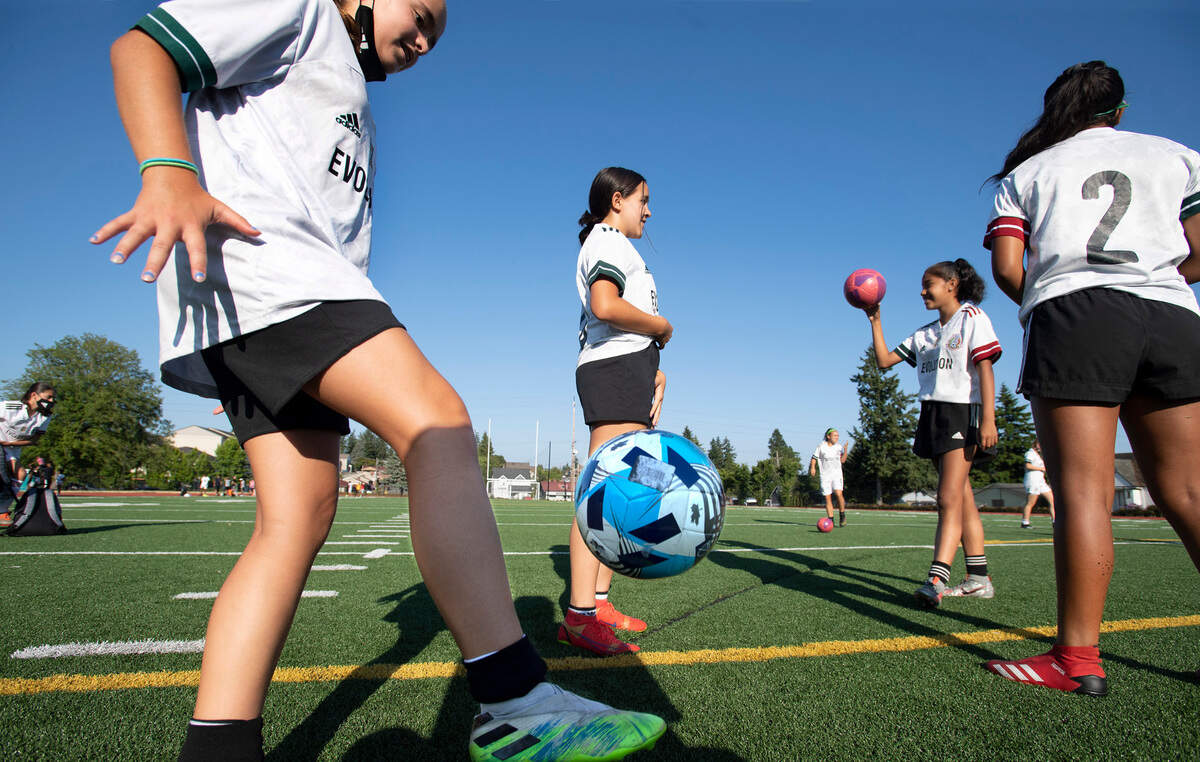 South Tacoma United Evolution U13 girls soccer team warms up before practice at Stewart Middle School in Tacoma, Washington, on Tuesday, July 13, 2021. The team will be competing in the national championship tournament in Colorado starting Friday.
