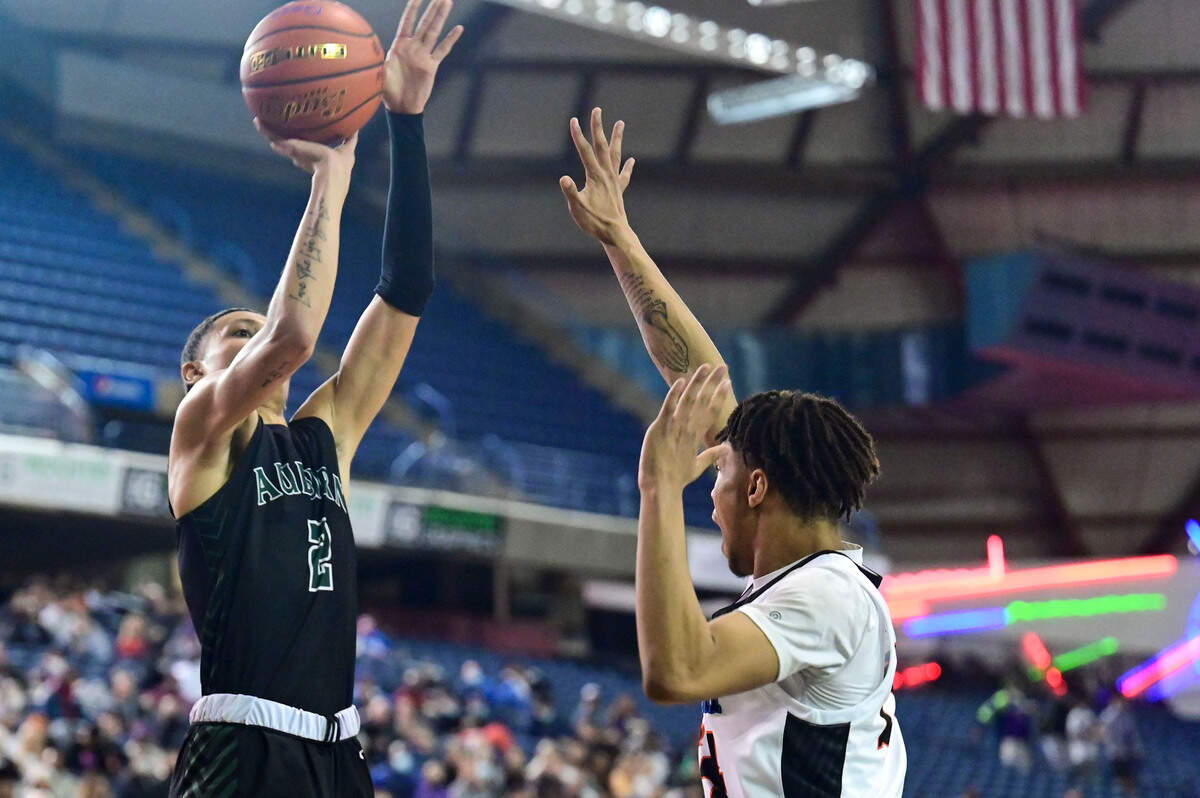 Auburn guard Trevon Blassingame (2) attempts a shot as Rainier Beach guard Mario Clark (24) defends during the fourth quarter of the Class 3A championship game on Saturday, March 5, 2022, at the Tacoma Dome, in Tacoma, Wash.