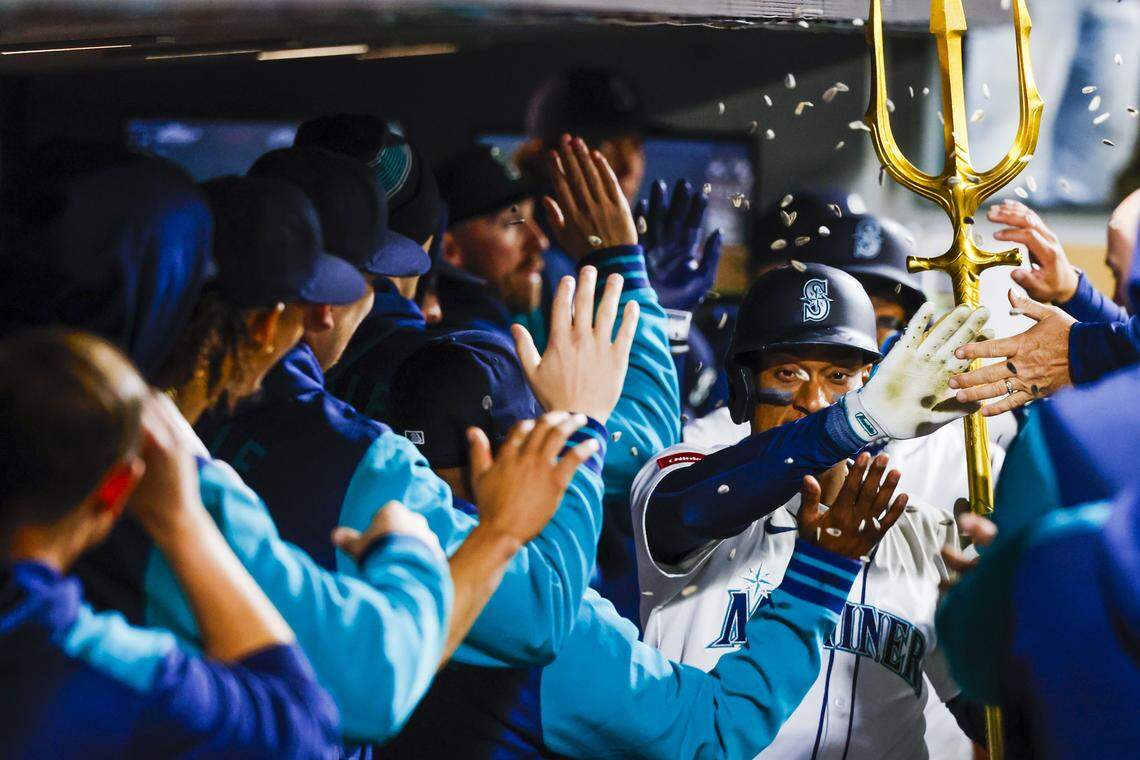 Apr 29, 2025; Seattle, Washington, USA; Seattle Mariners designated hitter Jorge Polanco (7) celebrates in the dugout after hitting a two-run home run against the Los Angeles Angels during the seventh inning at T-Mobile Park. Mandatory Credit: Joe Nicholson-Imagn Images