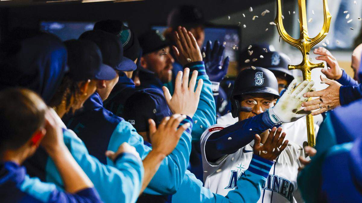 Apr 29, 2025; Seattle, Washington, USA; Seattle Mariners designated hitter Jorge Polanco (7) celebrates in the dugout after hitting a two-run home run against the Los Angeles Angels during the seventh inning at T-Mobile Park. Mandatory Credit: Joe Nicholson-Imagn Images