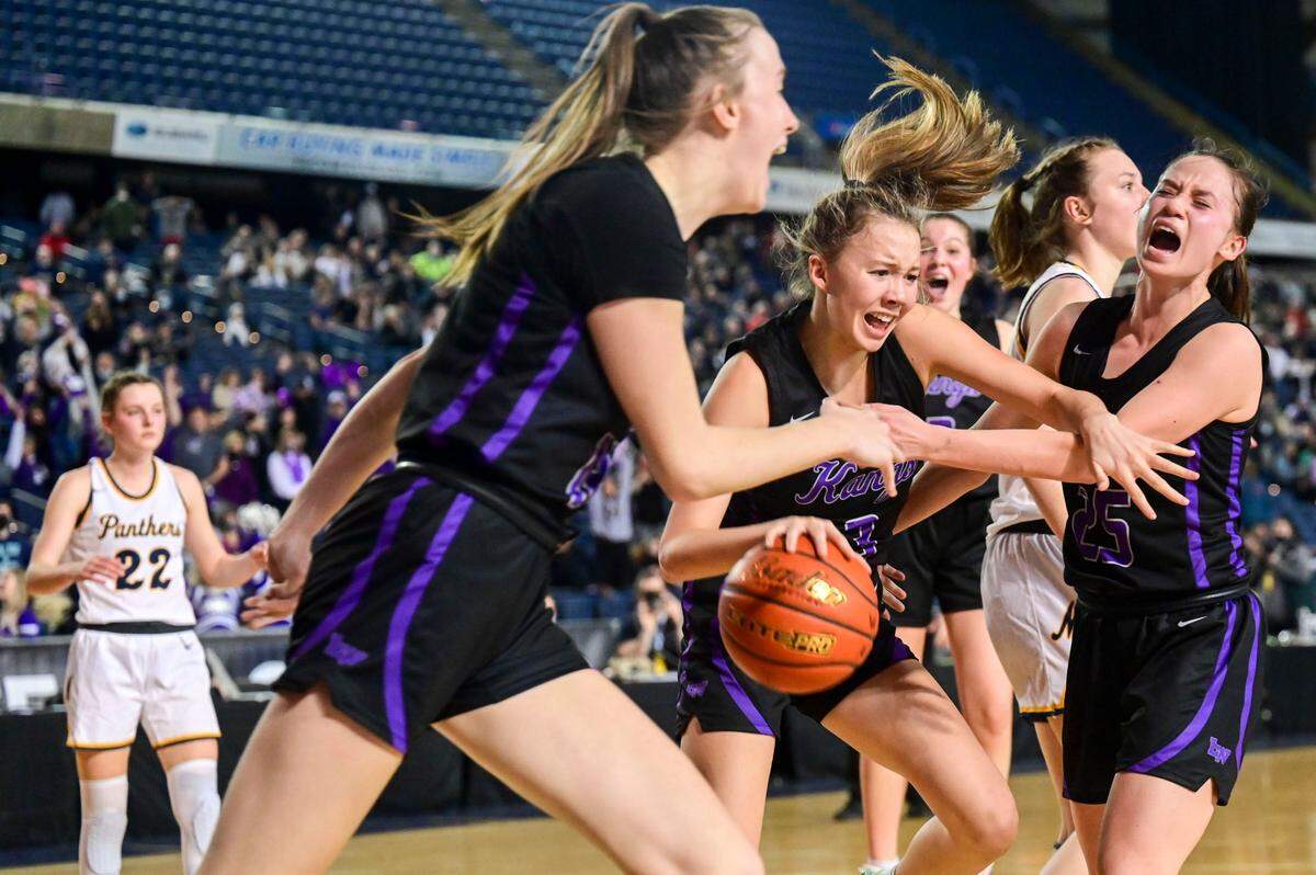 Lake Washington players celebrate after holding off a second-half comeback from Mead to win, 42-41, in a Class 3A semifinal state tournament game on Friday, March 4, 2022, at the Tacoma Dome, in Tacoma, Wash.