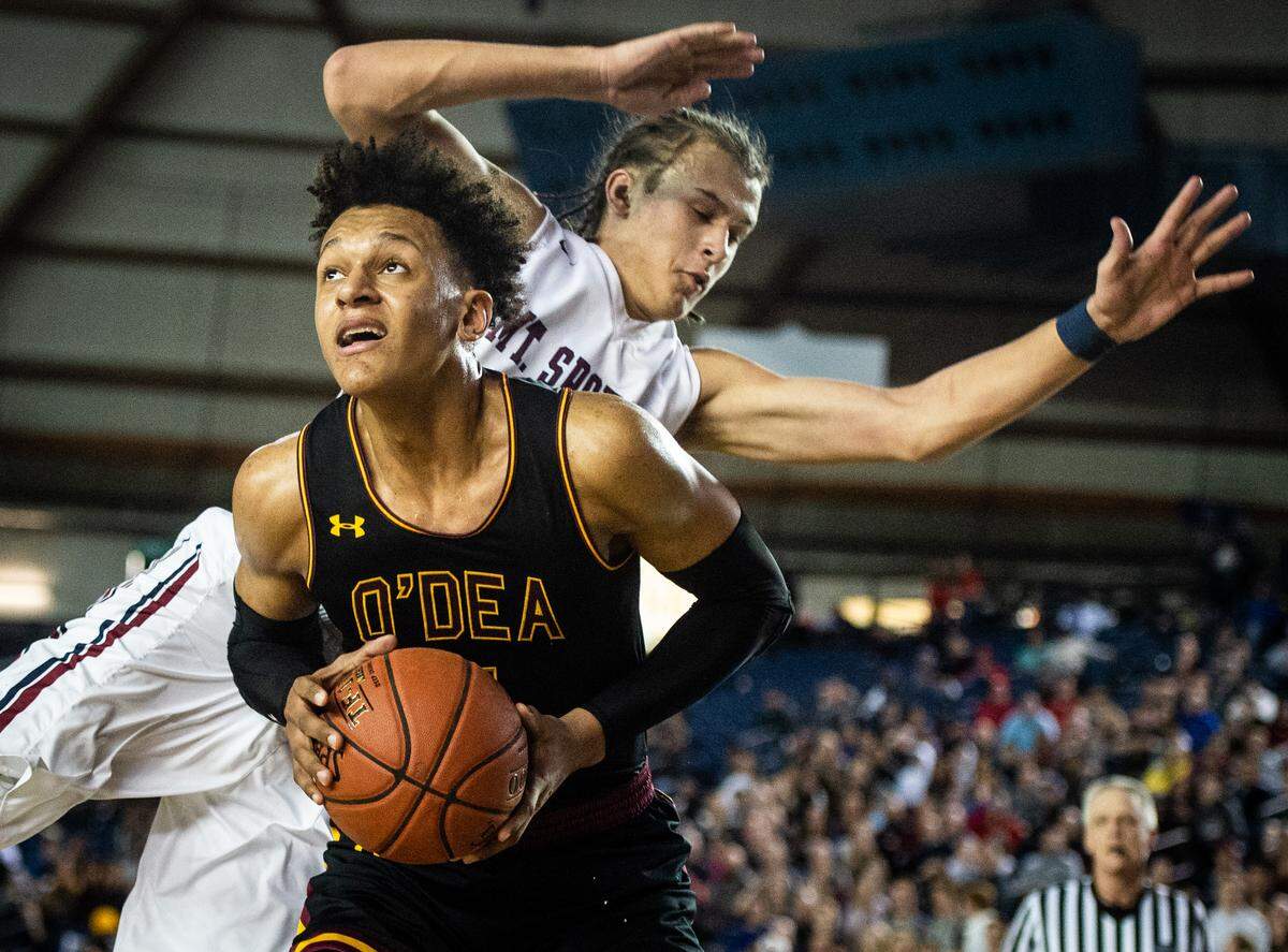 Mount Spokane’s Tyson Degenhart goes up and over O’Dea’s Paolo Banchero as Banchero goes up for a shot the third quarter. O’Dea played Mount Spokane in the 3A boys championship game at the Hardwood Classic State Basketball Tournament at the Tacoma Dome in Tacoma, Wash., on Saturday, March 2, 2019.