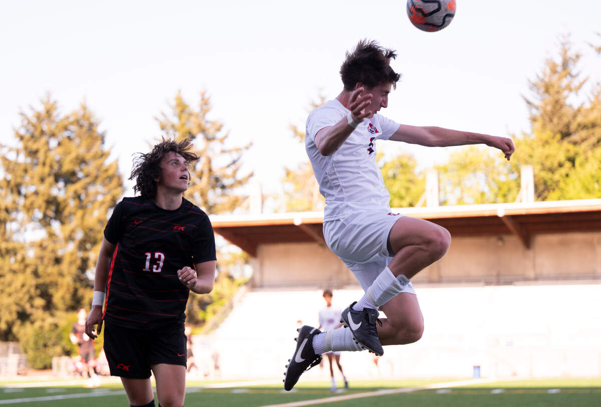 Silas’ Asa Chamberlin (3) heads the ball away from Central Kitsap’s Nicholas Strickland (13) during the 3A District Boys Soccer Championship match at Auburn Memorial Stadium, on Thursday, May 9, 2024, in Auburn, Wash.