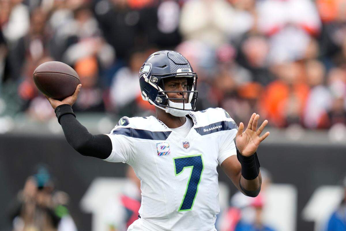 Seattle Seahawks quarterback Geno Smith throws during the first half of an NFL football game against the Cincinnati Bengals, Sunday, Oct. 15, 2023, in Cincinnati. (AP Photo/Michael Conroy)