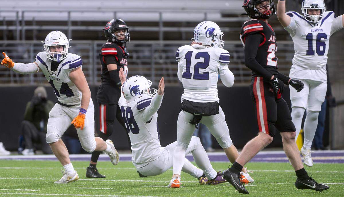 Sumner kicker Austin Ferencz (88) collapses to the turf after nailing the game-winning field goal as time expires in Saturday’s WIAA 4A state football championship game against the Camas Papermakers at Husky Stadium in Seattle, Washington, on Dec. 7, 2024. Sumner won the game, 27-24.