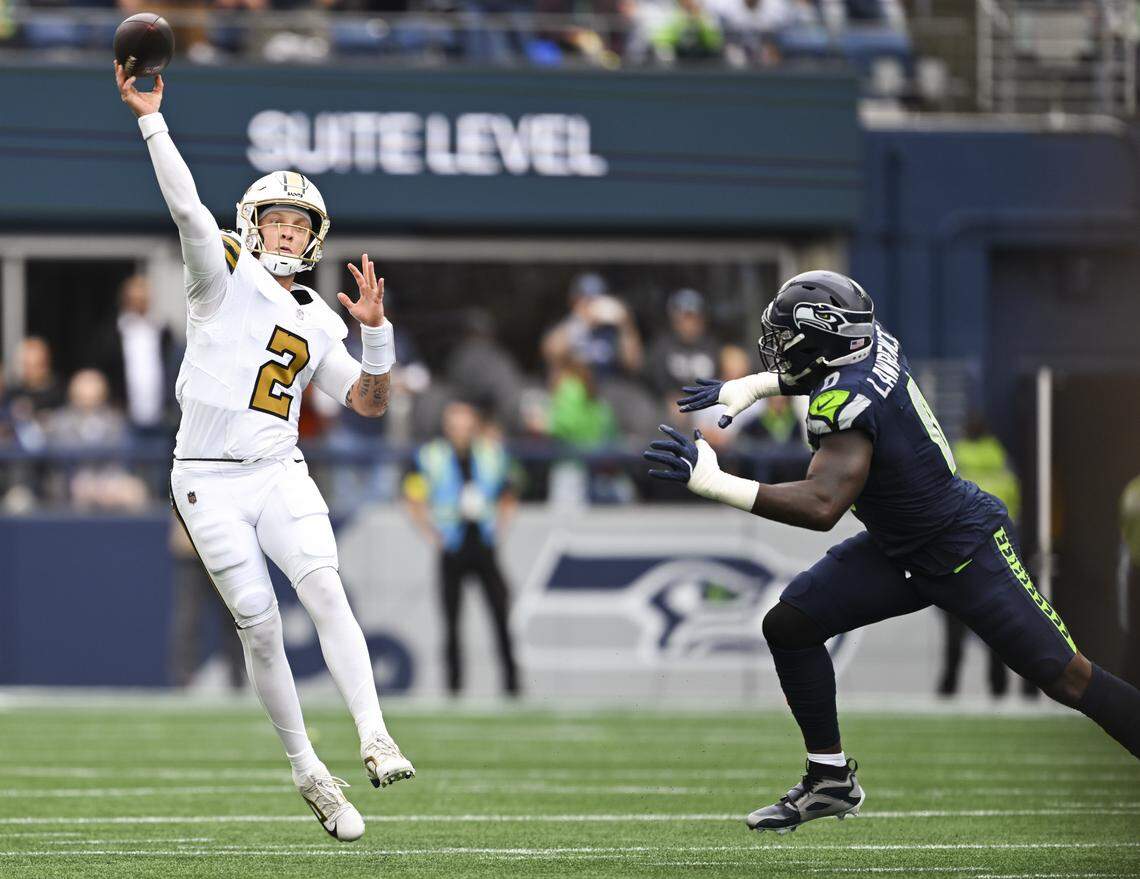New Orleans Saints quarterback Spencer Rattler (2) throws as Seattle Seahawks linebacker DeMarcus Lawrence chases him down during the first quarter of the game at Lumen Field, on Sunday, Sept. 21, 2025 in Seattle.