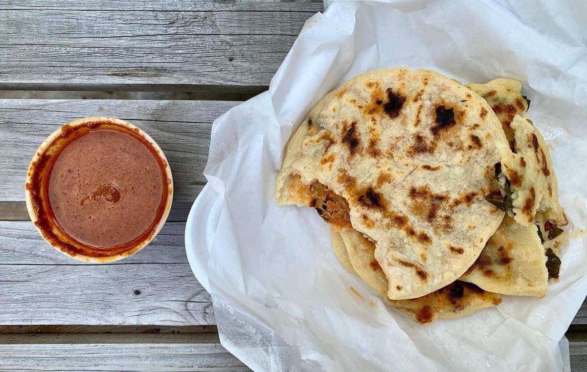 Made by hand and paired with a deep red, very spicy salsa, the pupusas at El Pulgarcito exemplify El Salvador’s national dish.