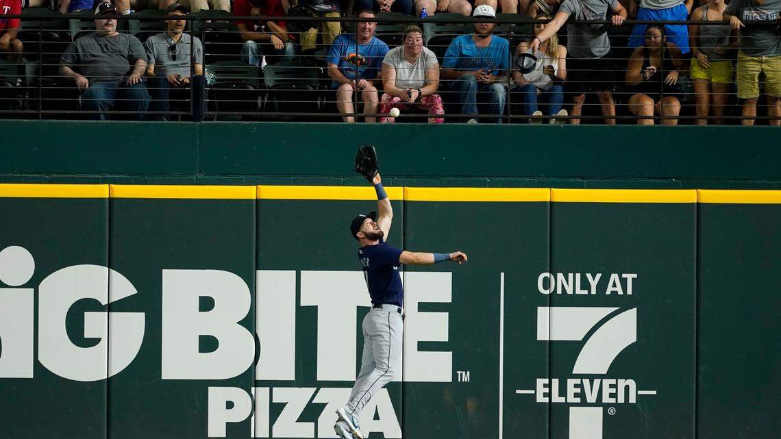 Seattle Mariners right fielder Mitch Haniger makes a leaping catch of a ball hit by Texas Rangers’ Leody Taveras during the second inning of a baseball game in Arlington, Texas, Friday, Aug. 12, 2022. Haniger threw to first to double off Nathaniel Lowe. (AP Photo/Tony Gutierrez)