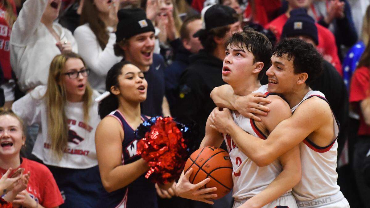 Black Hills’ Avery Armin (2) and Degan Hurley celebrate after Armin pulled down a rebound on a free throw in the final seconds of the game. Black Hills played Tumwater in a basketball game at Black Hills High School in Olympia, Wash., on Friday, Jan. 24, 2020.