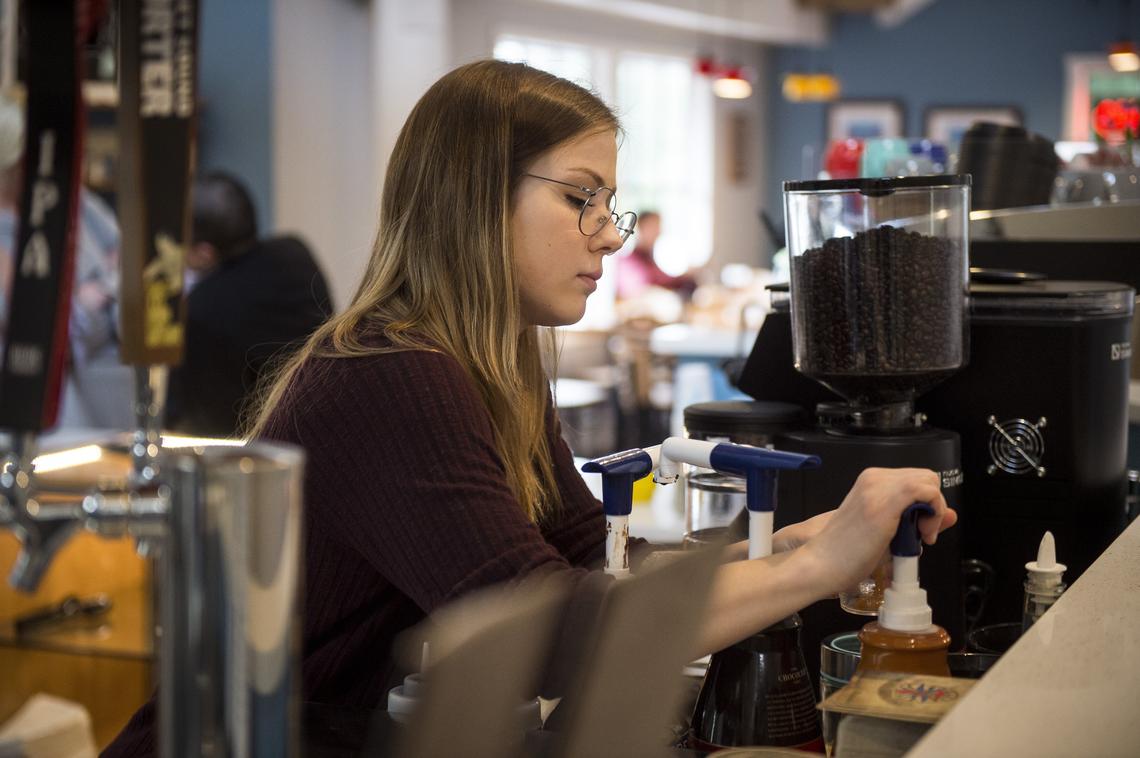 Chloe Dullum prepares a drink inside the recently opened Kimball Coffeehouse in Gig Harbor, Wash., on Thursday, April 5, 2018. After the Kimball Espresso was forced to close due to redevelopment of their building, the Dullum family purchased the business, moved it down the street, and reopened it as the Kimball Coffeehouse.